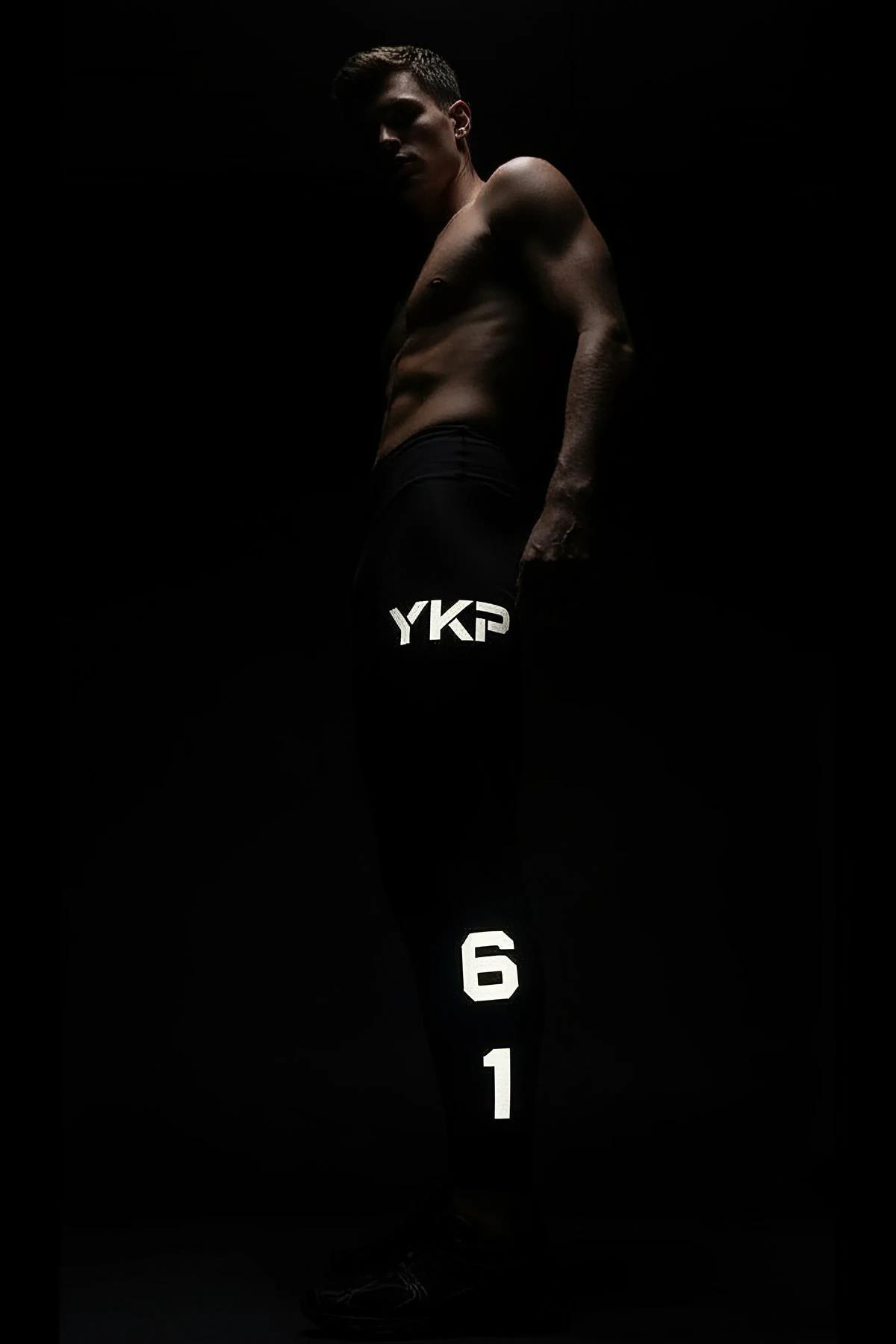 Black Reflective Sport Joggers with MRT Logo and 98 Graphic Worn by Man