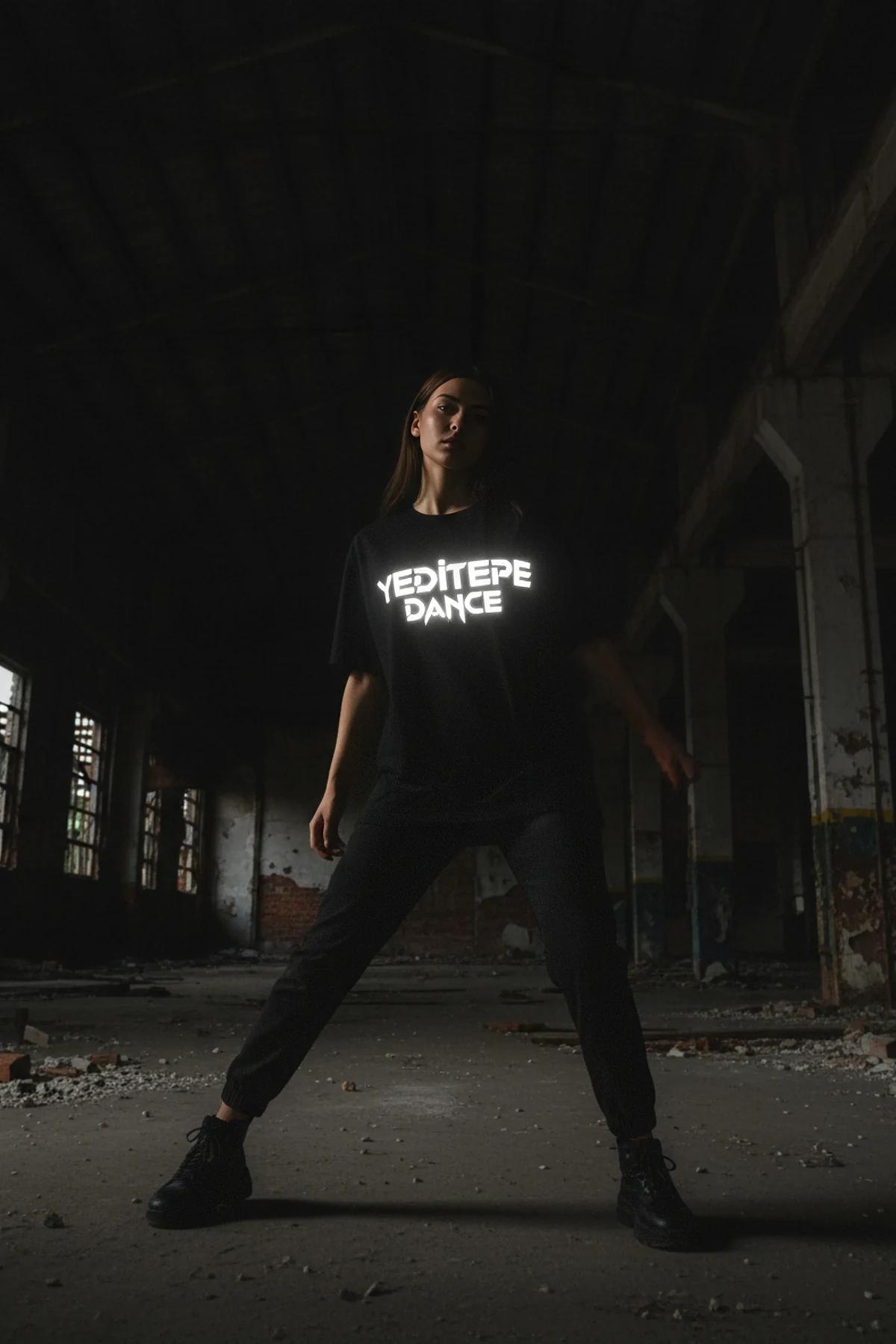 Back view of the black cotton t-shirt, showing its relaxed fit.