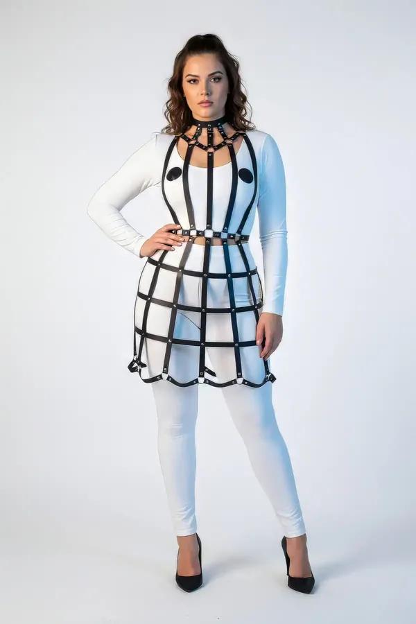 black faux leather lattice grid full body harness with multi-strap choker and matte stud rivets worn over white bodysuit