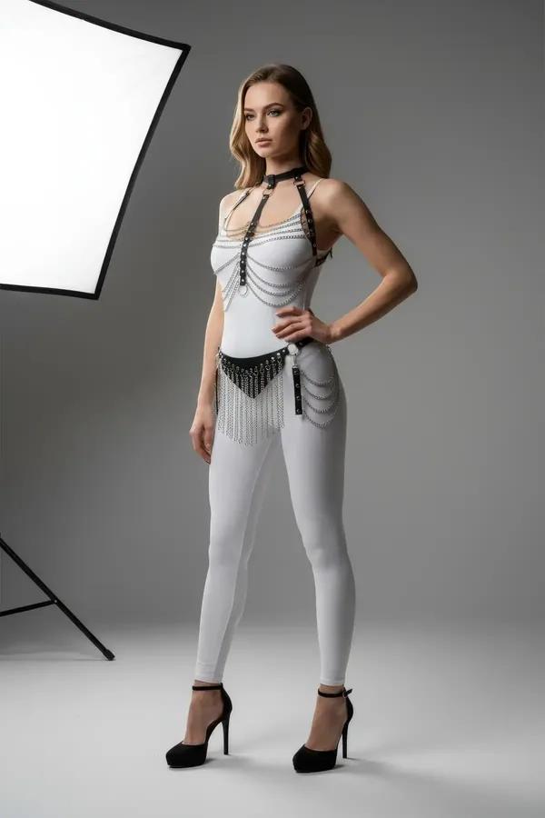 black faux leather body harness with draped silver chain skirt and integrated collar, full-body view