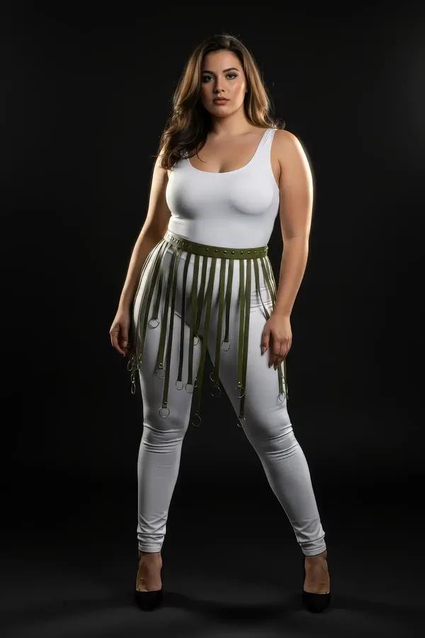 Olive green faux leather fringe waist harness with silver O-rings worn over white leggings, mid-thigh strap drop