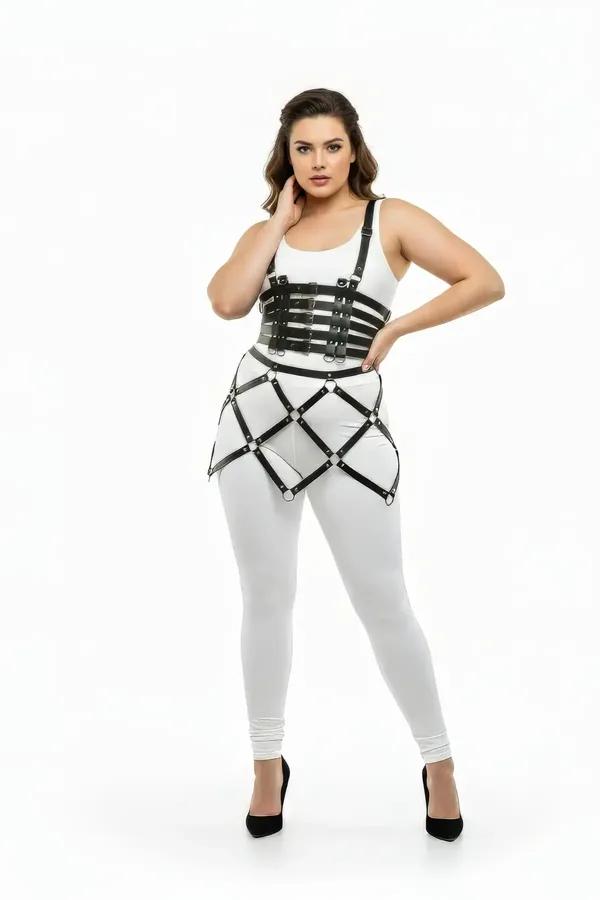 black faux leather cage body harness skirt with five underbust straps and silver o-ring cage skirt worn over white bodysuit a