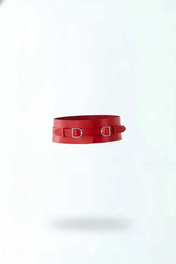 red faux leather wide waist cinch harness belt with dual silver D-ring buckles front view