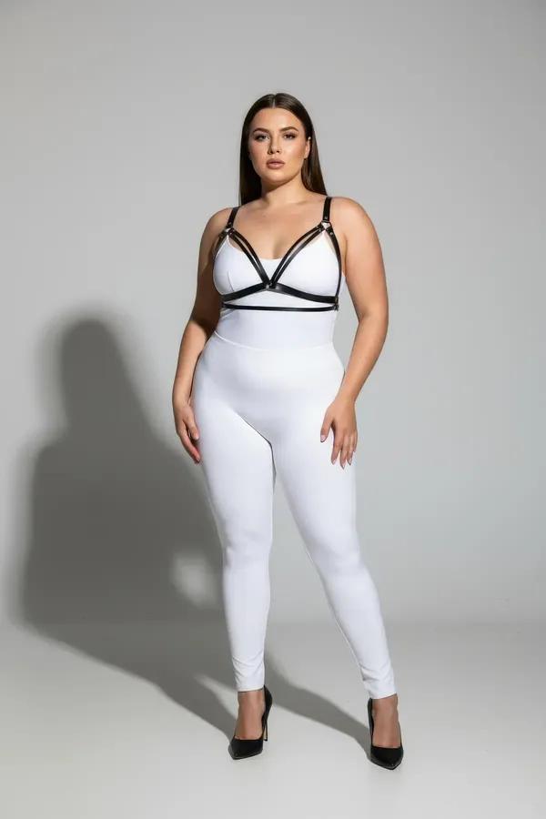 black faux leather harness bra with triple V-chest straps and silver buckles worn over white bodysuit