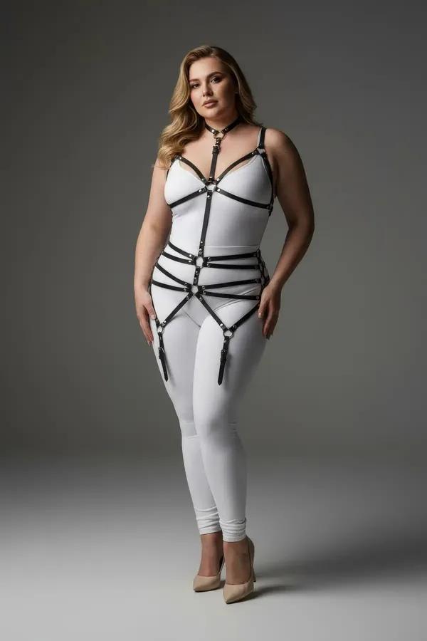 black faux leather full body harness with choker collar, O-ring chest cage, three waist bands, and dangling garter straps on