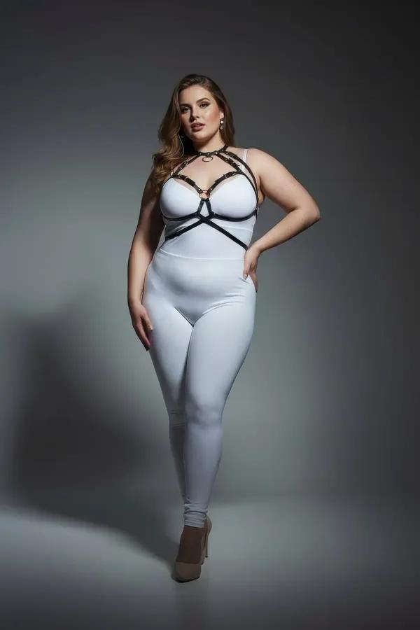 black faux leather strappy o-ring chest harness with gold buckles worn over white bodysuit plus size model