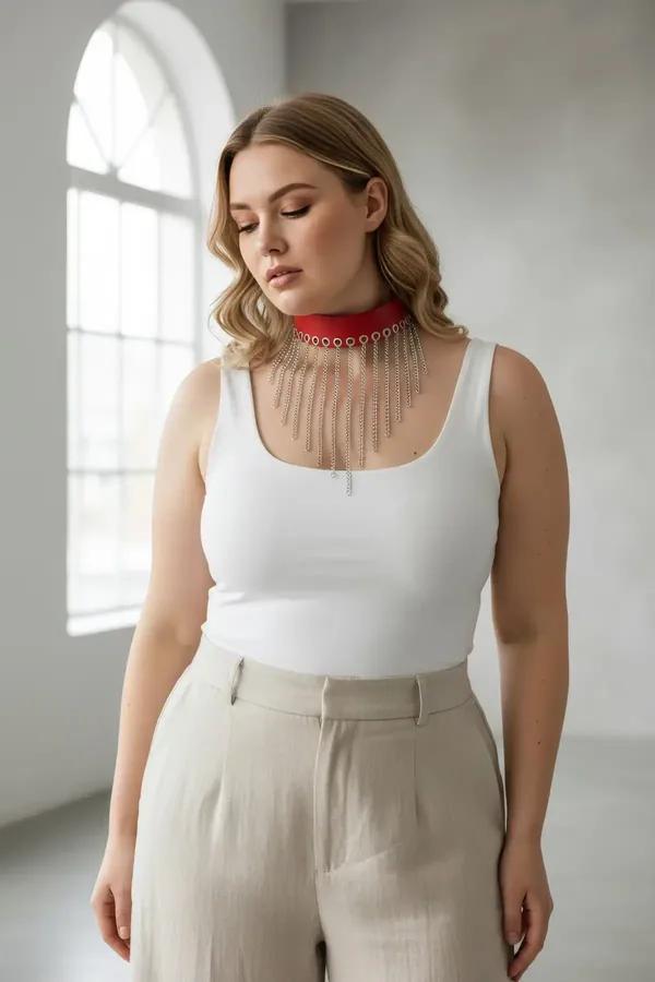 red faux leather choker with cascading silver chain tassels draped across chest worn over cream camisole