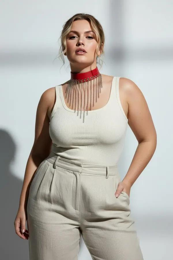 red faux leather choker with cascading silver chain tassels draped across chest worn over cream camisole