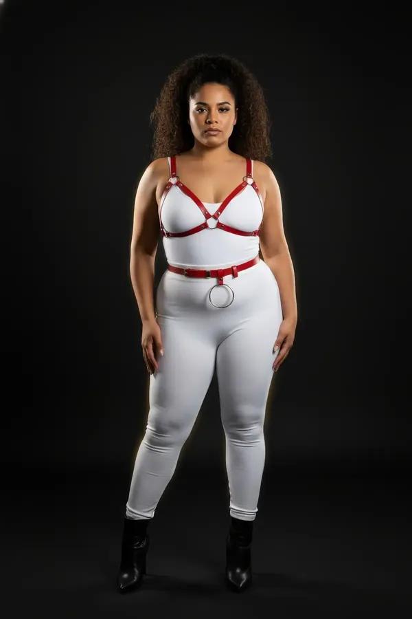 red vegan leather chest harness and waist belt set with silver O-ring on plus-size model over white bodysuit