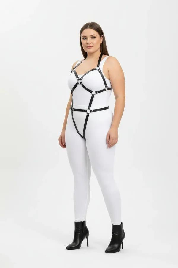 Black vegan leather full body harness with silver O-rings, wide chest frame and leg straps, worn on plus-size model