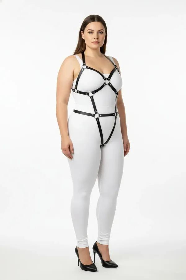 Black vegan leather full body harness with silver O-rings, wide chest frame and leg straps, worn on plus-size model