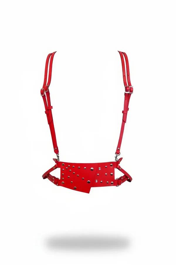Red faux leather asymmetrical studded underbust harness with silver dome studs and adjustable shoulder straps