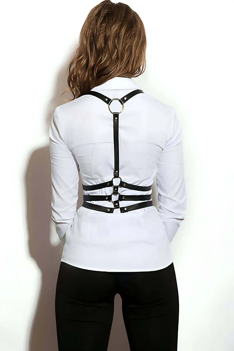 Close-up of black faux leather chest harness buckle detail