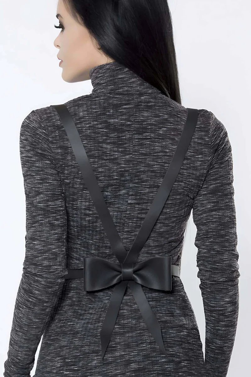Black faux leather body harness detail with a large satin bow accent