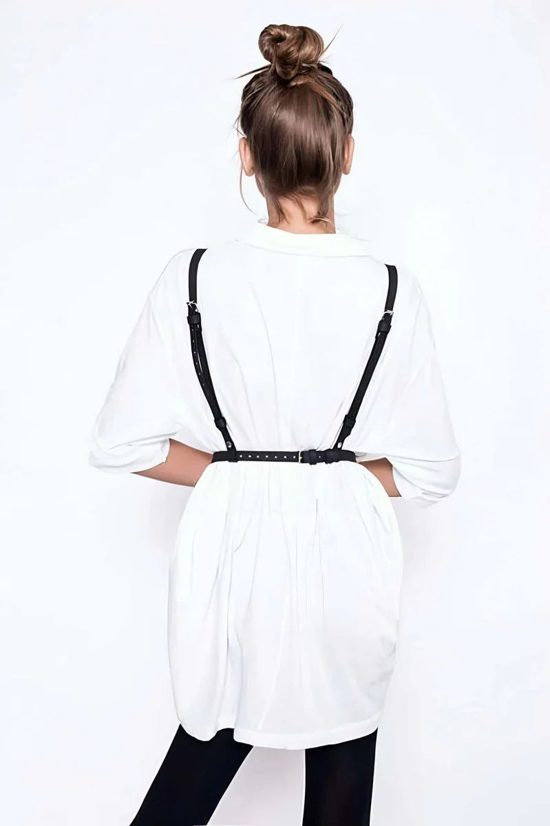 Black faux leather chest harness with adjustable straps and O-ring detail