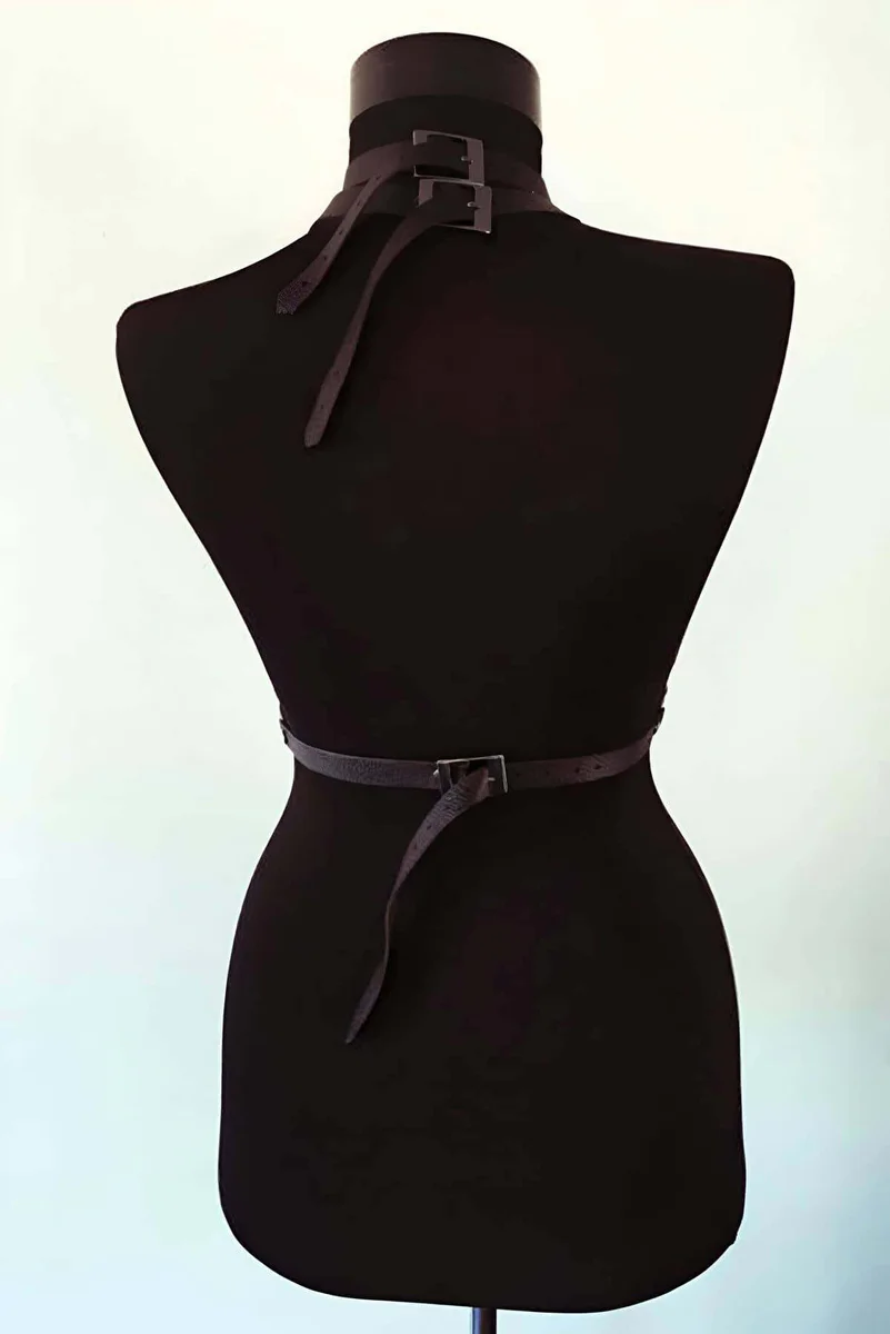 Back view of adjustable black faux leather harness with buckle details