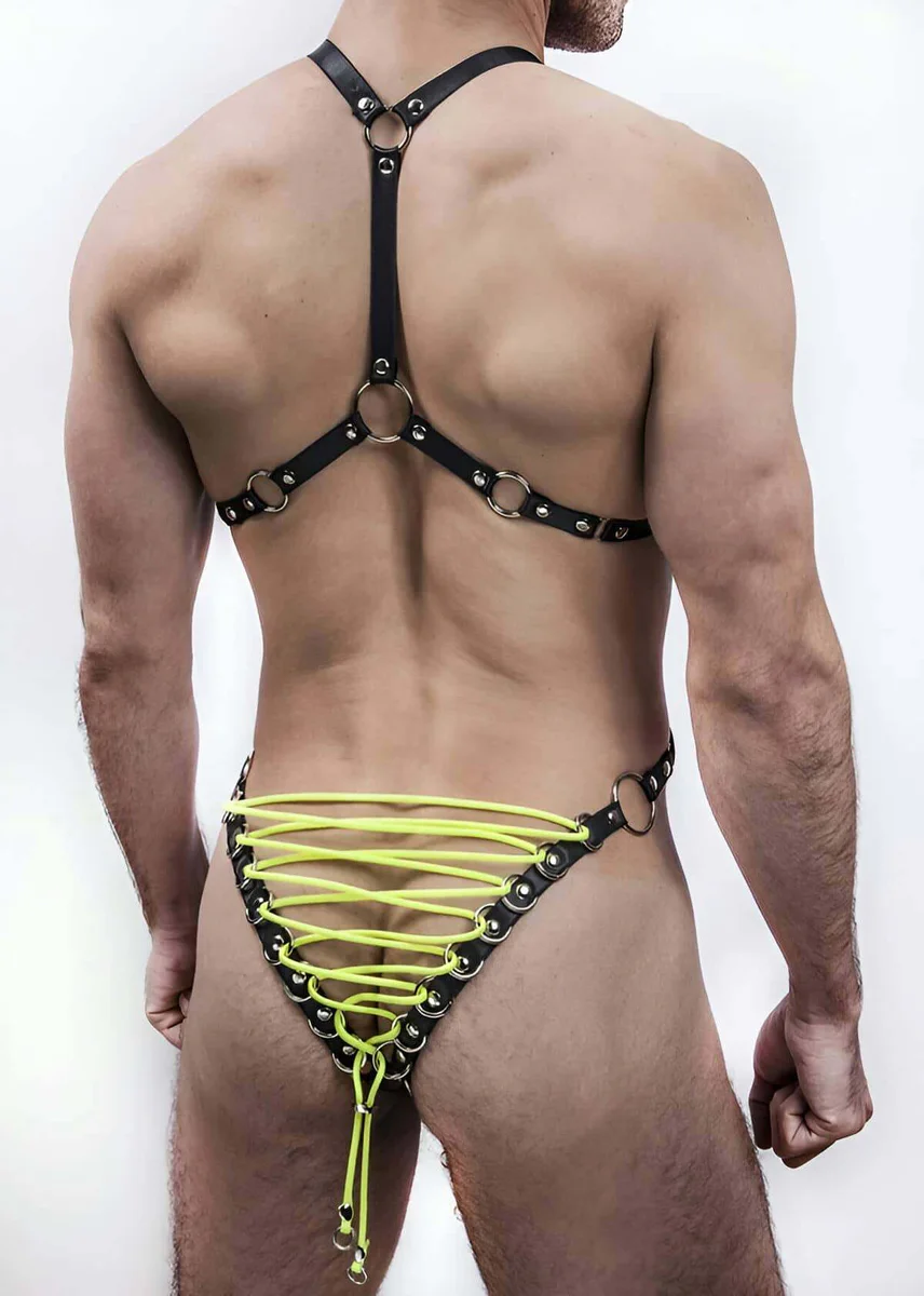Close-up of neon yellow lacing detail on black faux leather harness