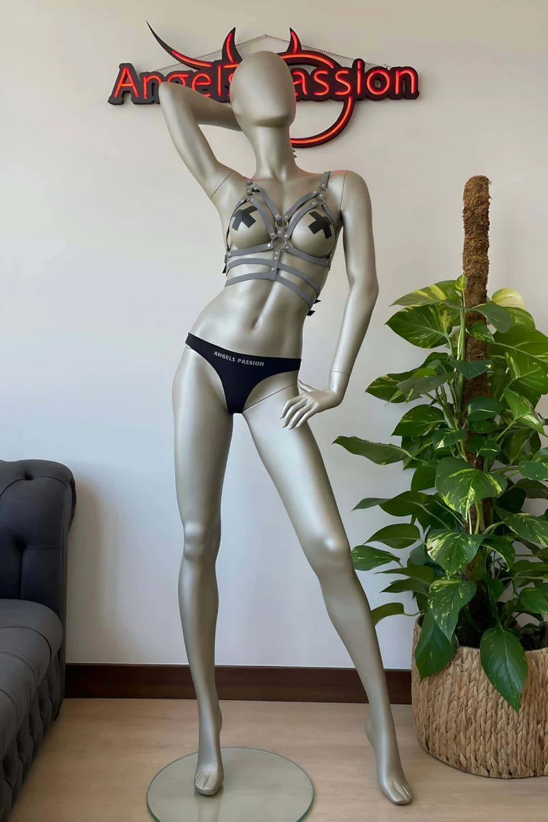Reflective silver chest harness with matching choker set on mannequin in festival outfit display