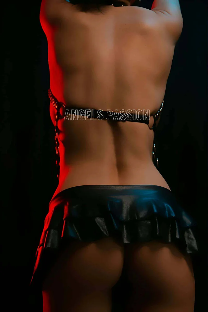 Black faux leather body harness with O-ring details and ruffled mini skirt
