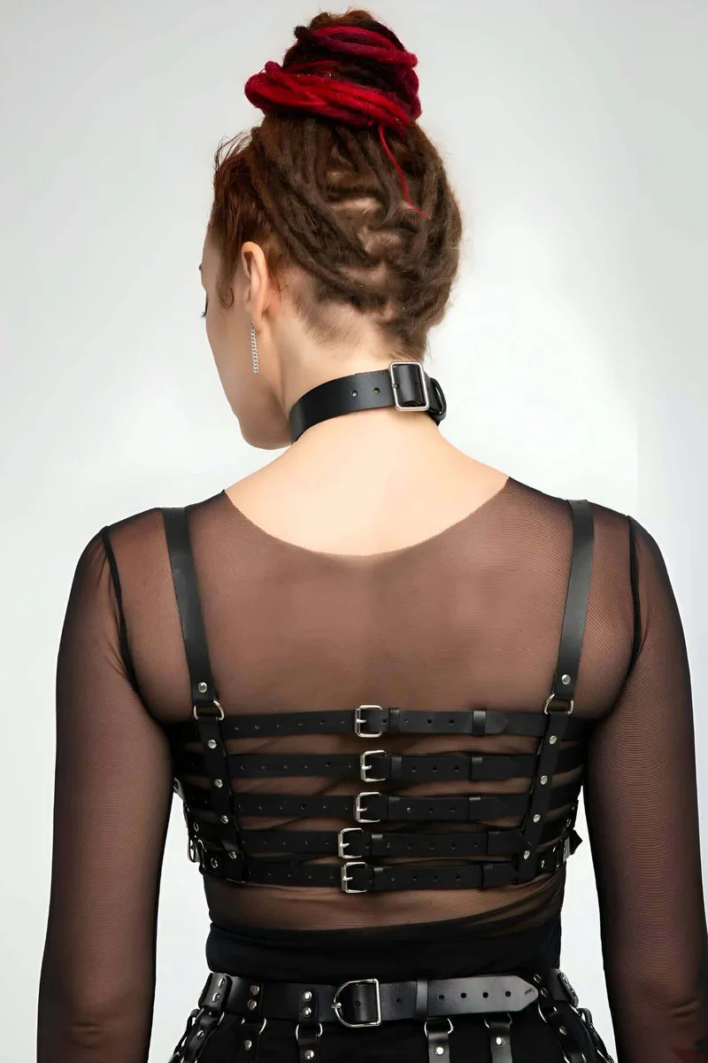 Model wearing black full body harness with O