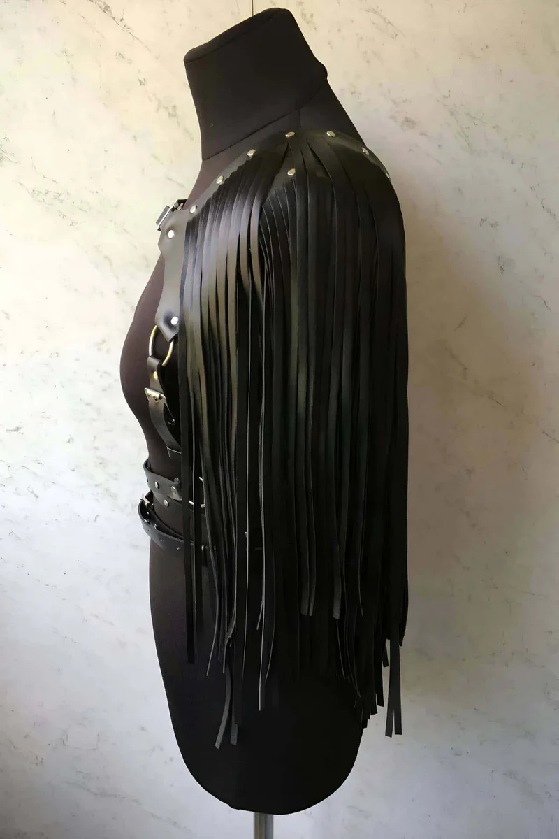 Close-up of black faux leather fringe detail on shoulder strap