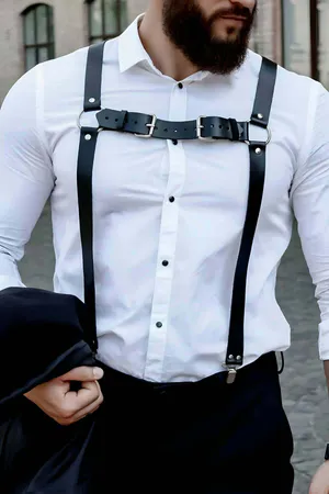 Black faux leather Y-back body harness with O-ring, worn over a white shirt