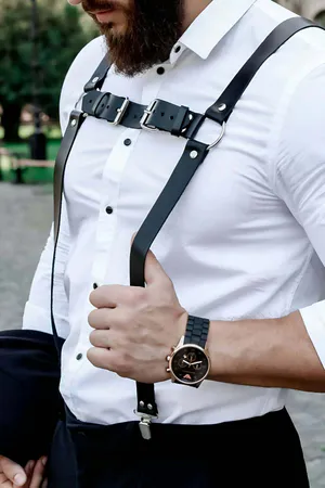 Black faux leather Y-back body harness with O-ring, worn over a white shirt