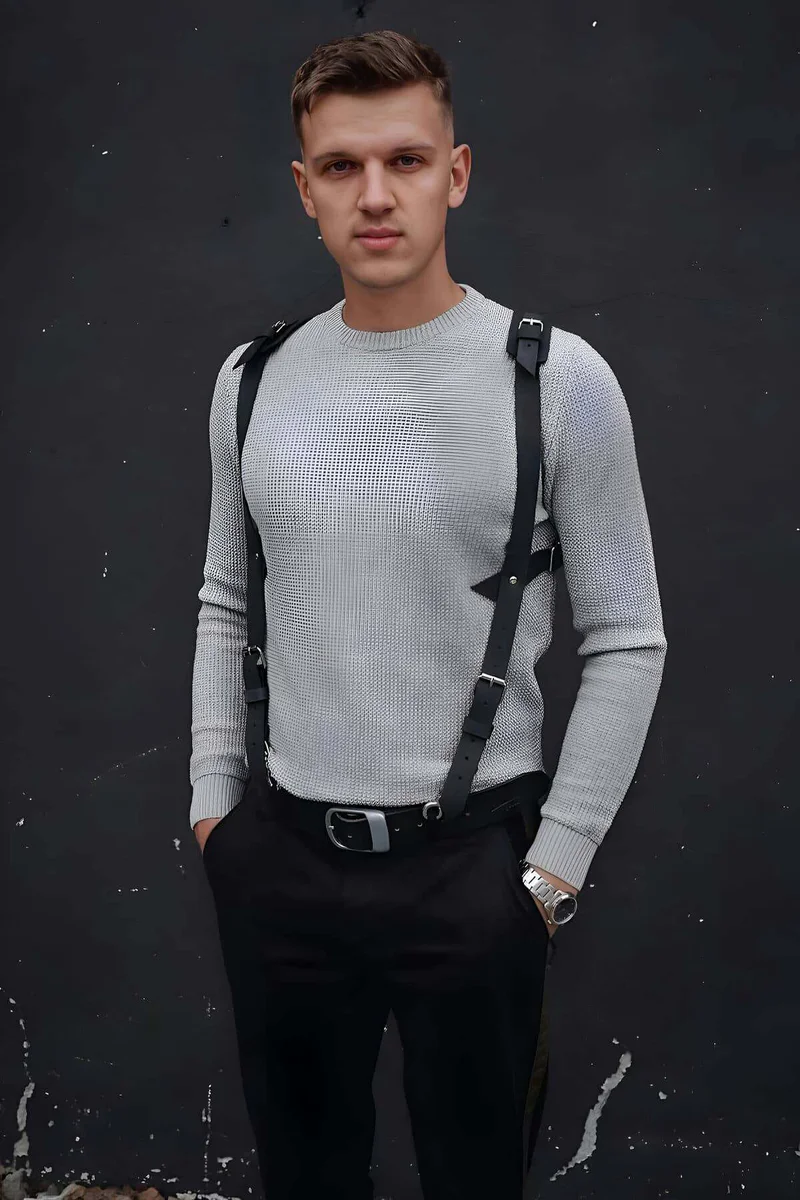 Side view of black faux leather chest harness showing strap configuration and buckle details