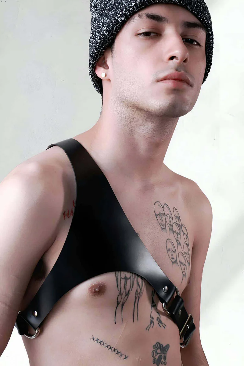 Close-up of silver buckle on black faux leather shoulder harness