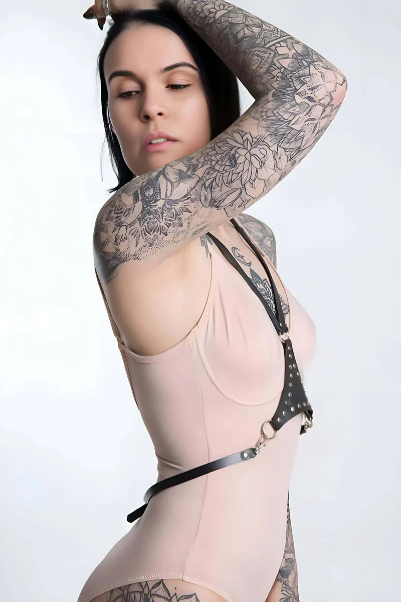 Adjustable neck strap detail on black faux leather chest harness