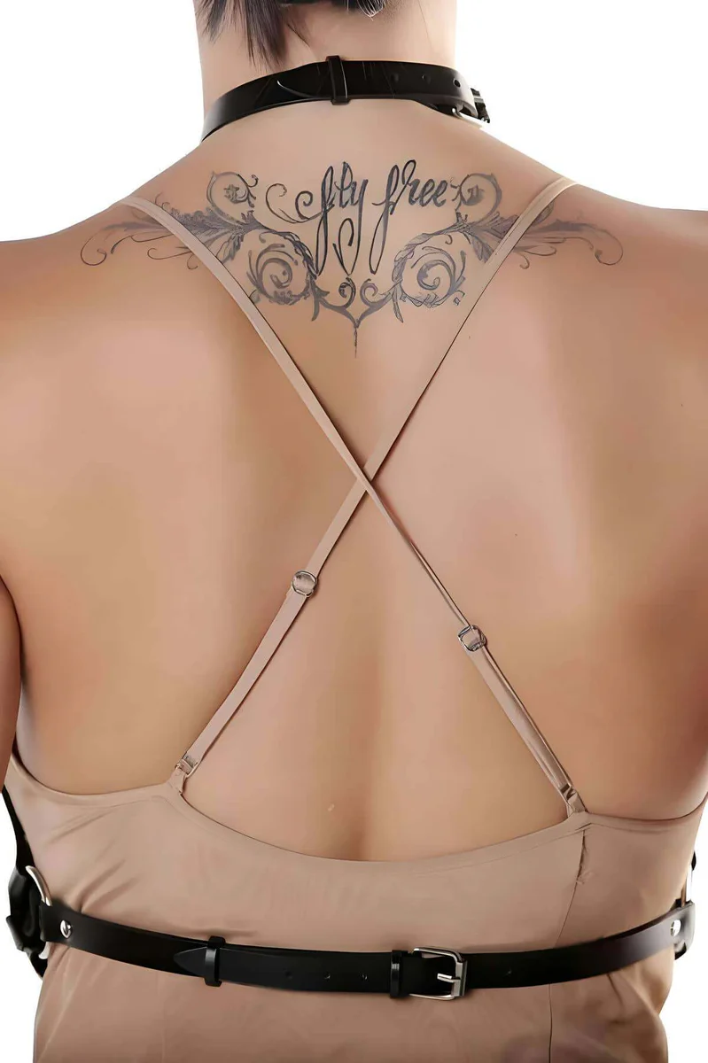 Adjustable neck strap detail on black faux leather harness featuring criss-cross straps