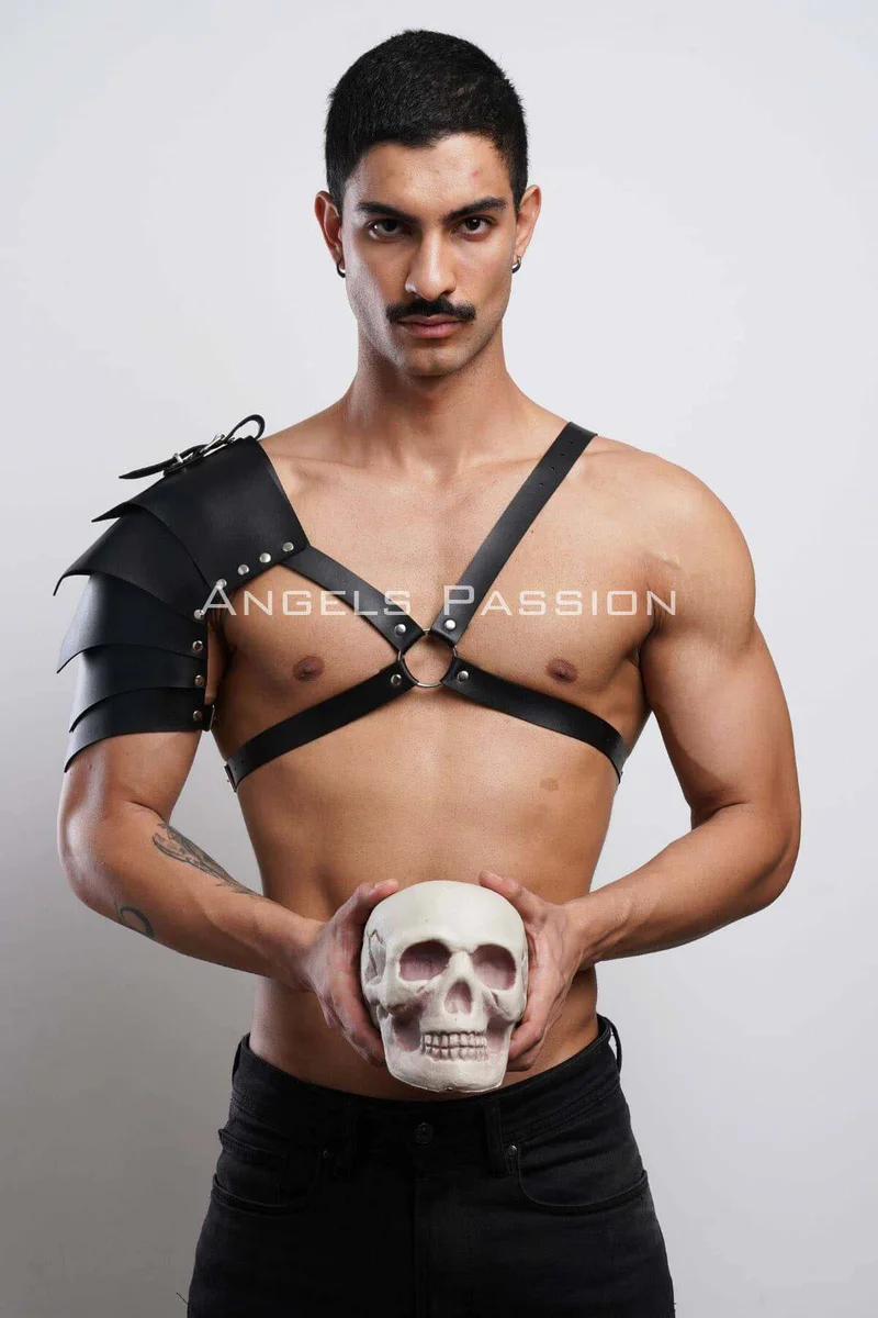 Black leather shoulder harness adjustable chest straps with silver O-ring hardware and shoulder armor