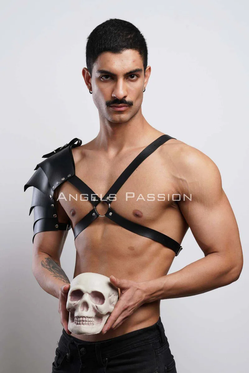 Black leather shoulder harness with chest straps and shoulder armor detail
