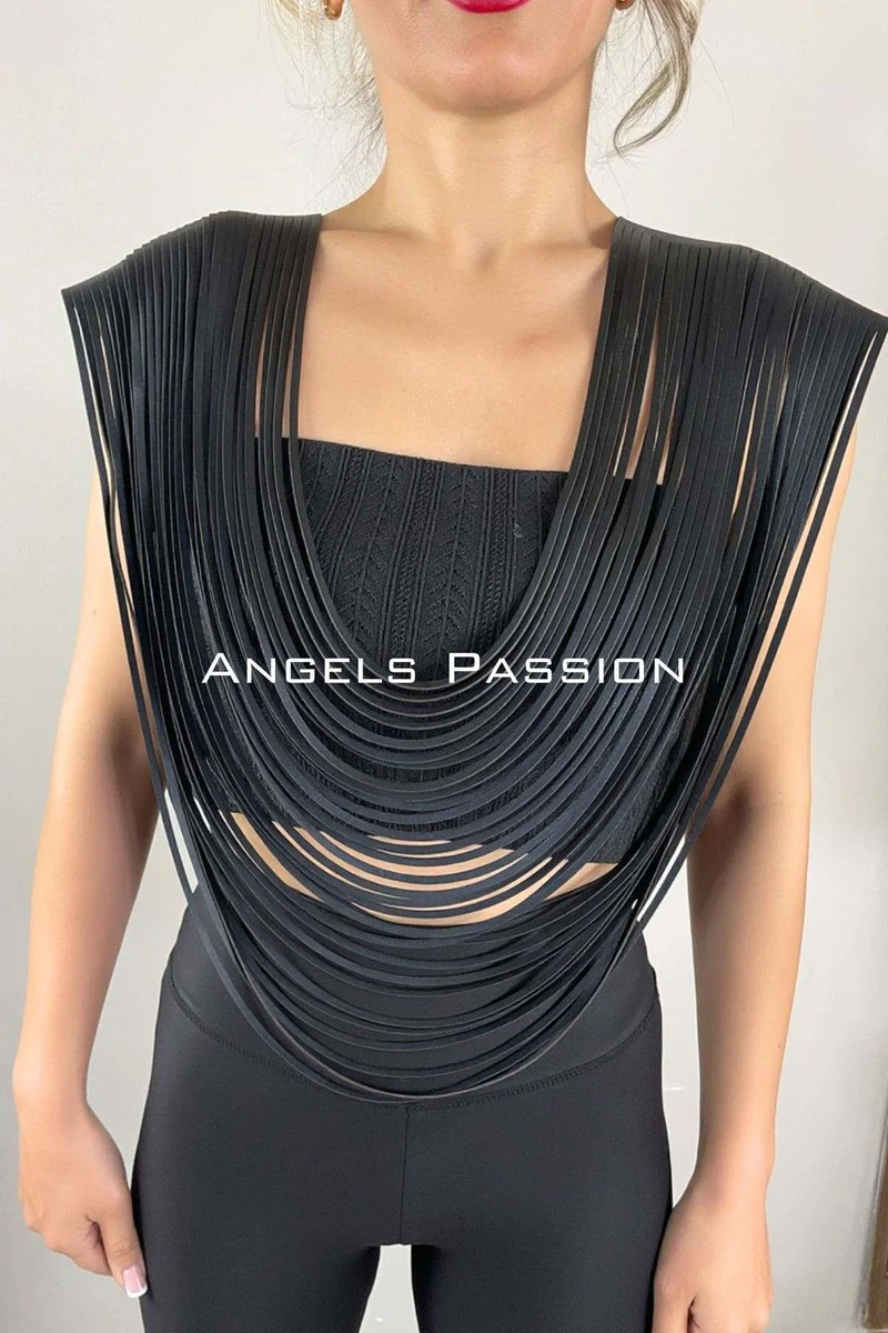 Close-up of layered fringe detail on black shoulder harness with a draped neckline