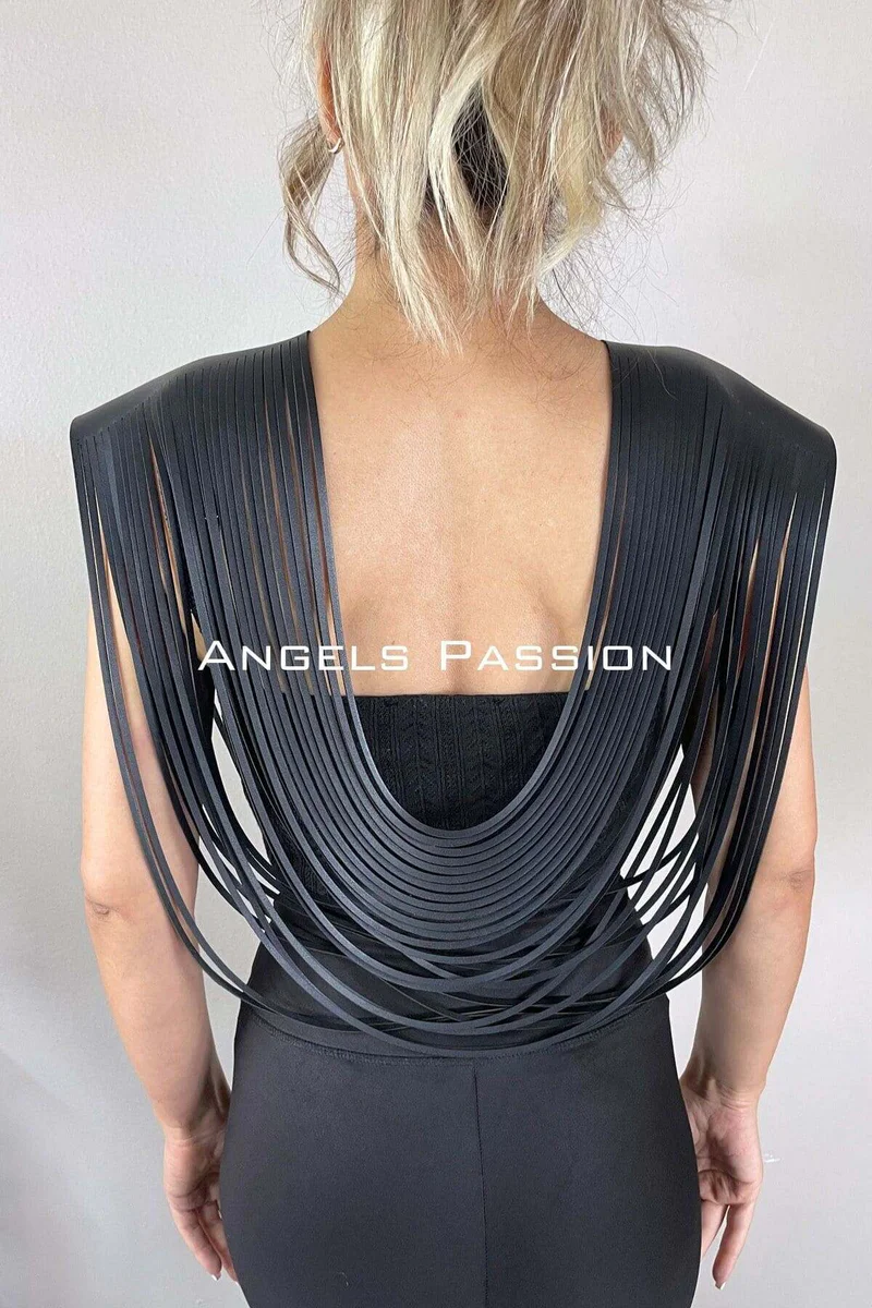Side profile of woman wearing black fringe shoulder harness with draping straps