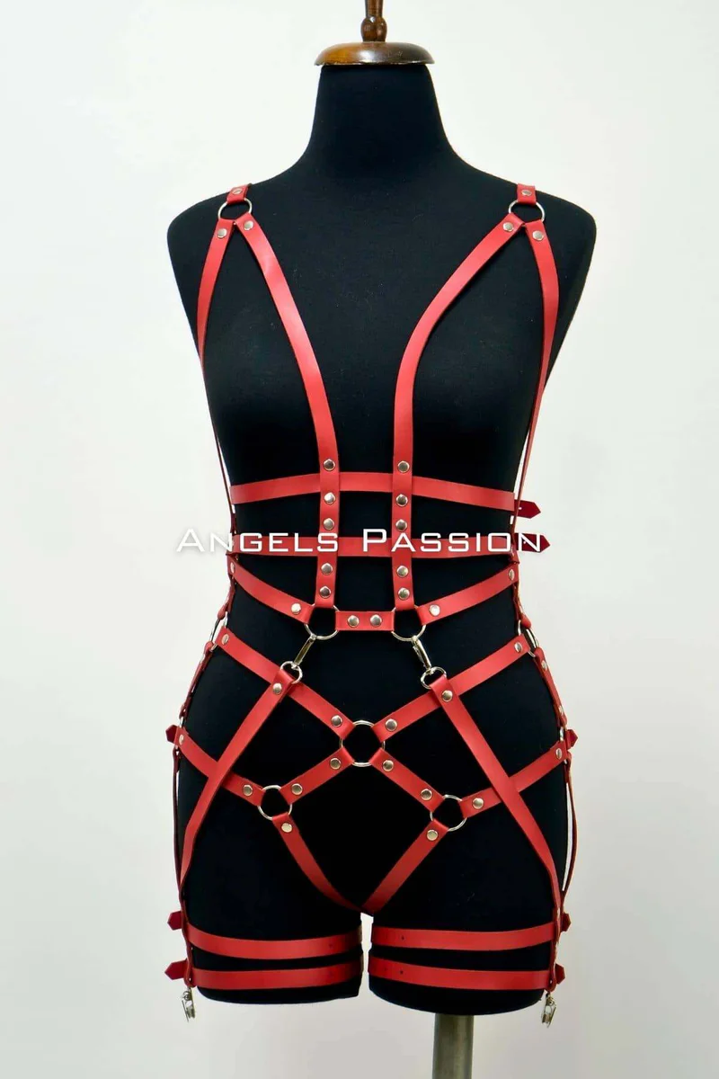 Red faux leather body harness with O-ring hardware and strap detailing on a mannequin