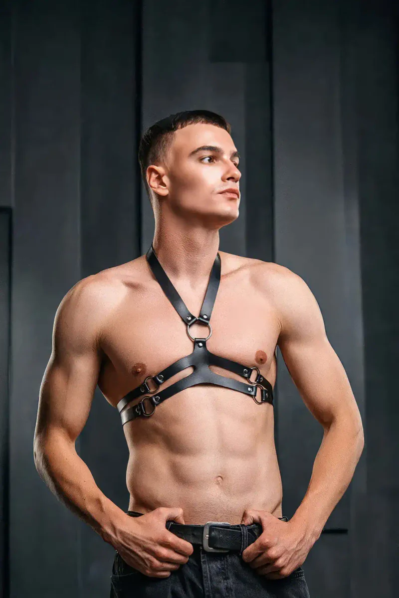 Side view of black faux leather chest harness showing strap configuration