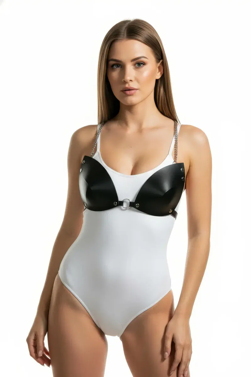 Model wearing the black harness bra and white bodysuit, showing full body