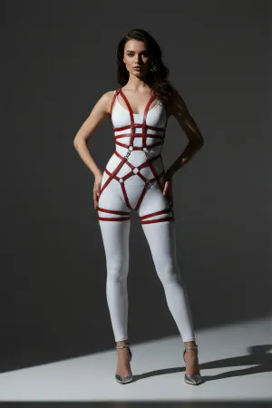 Red Faux Leather Full Body Cage Harness for Women with Silver O-Rings, worn over a white jumpsuit