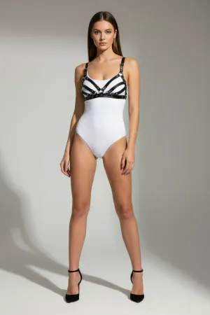 Black faux leather strappy chest harness worn by a model, showing multiple horizontal bands