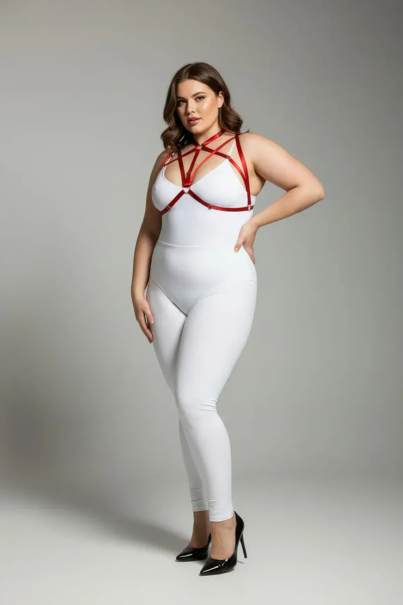 Red faux leather strappy chest harness with O-ring detail worn by a plus-size model