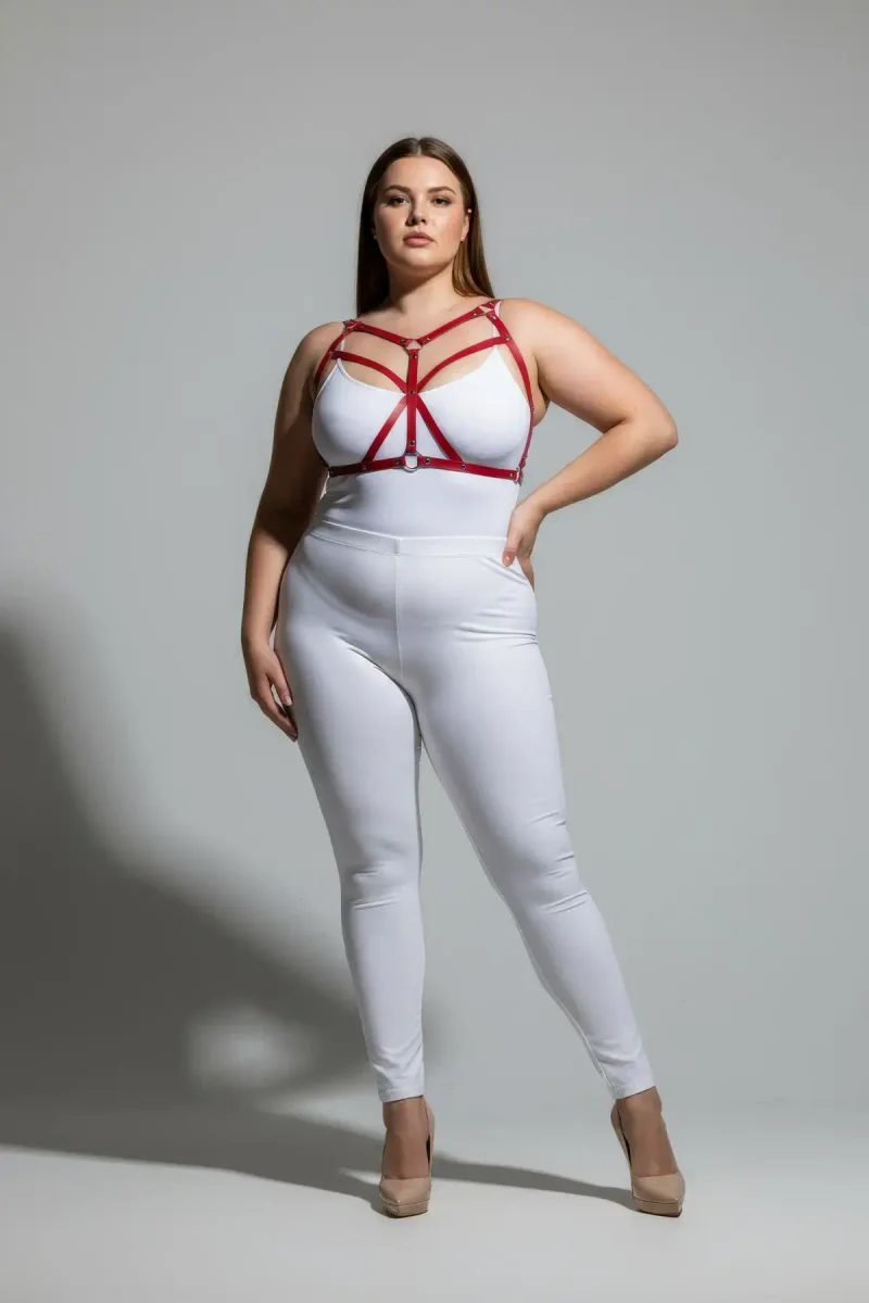 Plus size model wearing red body harness side profile detail