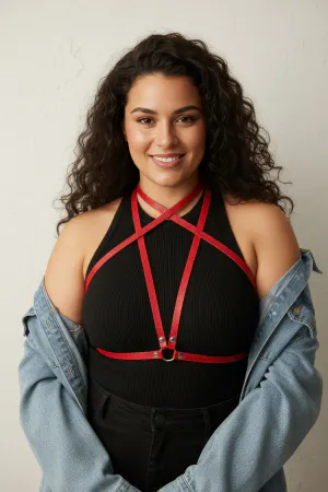 Red Vegan Leather Overbust Criss-Cross Body Harness with O-Ring worn by a woman over a black dress