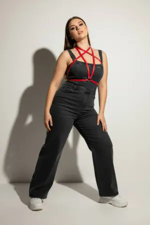 Red Vegan Leather Overbust Criss-Cross Body Harness with O-Ring worn by a woman over a black dress