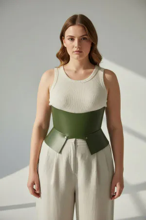 Khaki Faux Leather Corset Belt with Peplum Waist Detail worn by a woman in a fashion alley