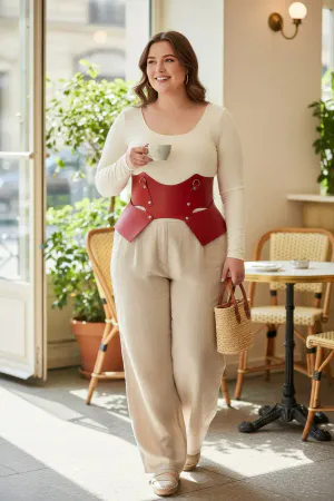 Red Faux Leather Waist Harness with Sculpted Panels on a woman in a cafe, light-colored blouse and pants