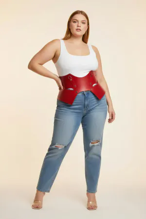 Red Faux Leather Waist Harness with Sculpted Panels on a woman in a cafe, light-colored blouse and pants