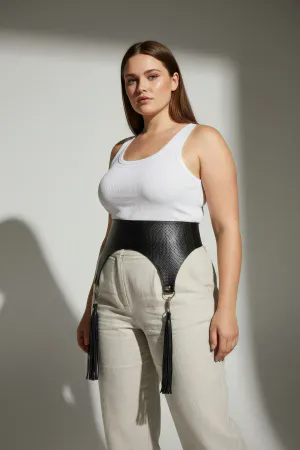 Black Faux Leather Waist Harness Belt with Tassels on a woman in a cafe