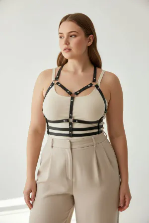 Black Vegan Leather Caged Chest Harness over beige top, featuring silver-toned stud details