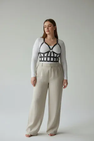 Black Caged Faux Leather Body Harness with Studded Grid Design worn over a white t-shirt